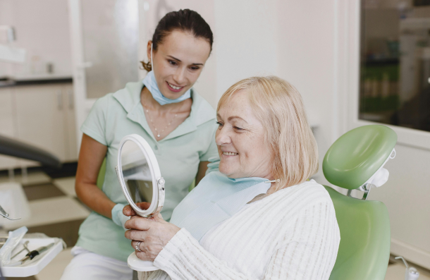 Dental Exam lady at dentist holding a mirror