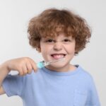 child with toothbrush