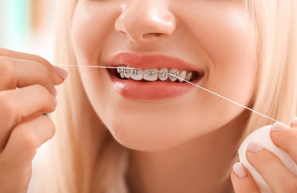 lady flossing fixed braces